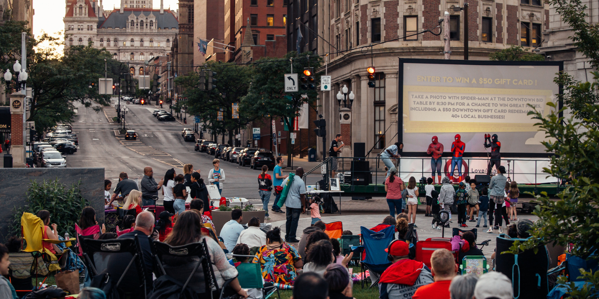 People watch movie at SUNY Plaza in downtown Albany, NY