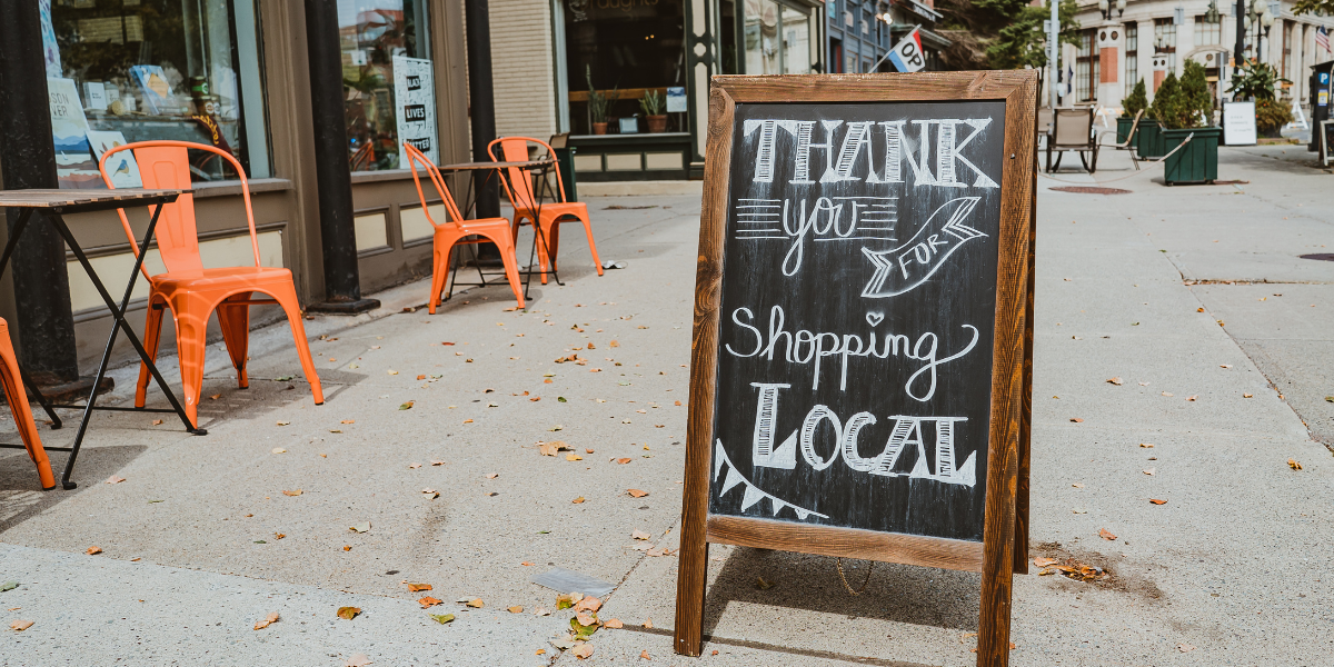 A-Frame chalkboard that reads "thank you for shopping local"