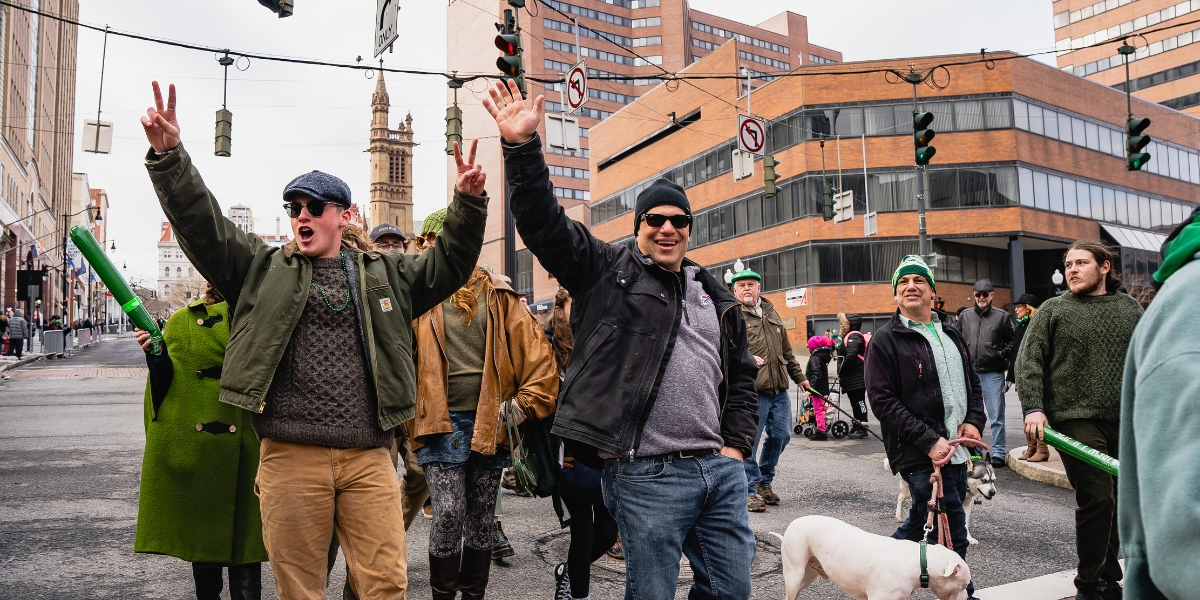 A group of people marching down State Street for the St. Patrick's Day parade