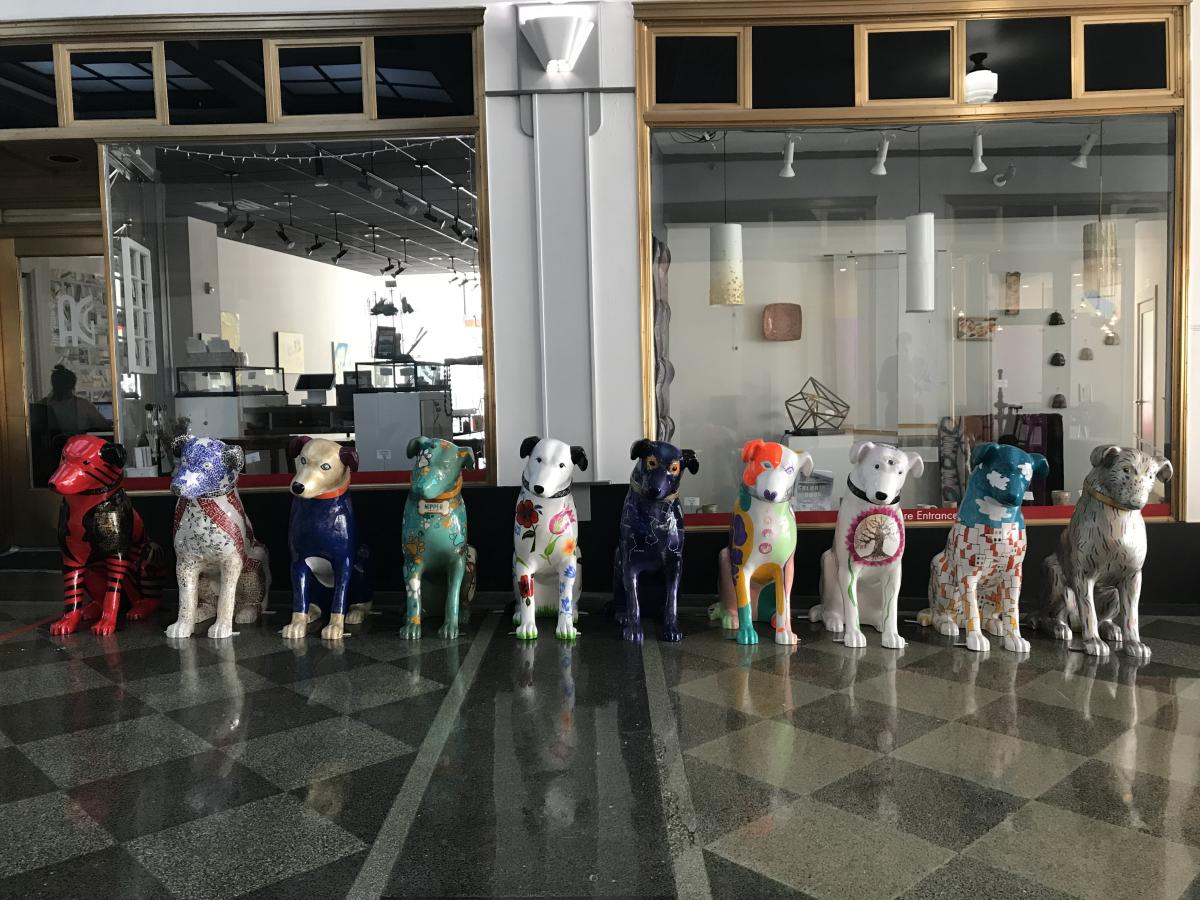 Four Dog Sculptures of different colors 