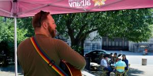 Ryan Leddick playing music outside in Downtown