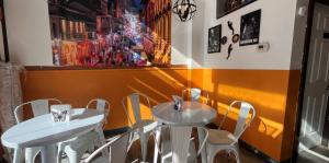 Photo of Beignet Bellies, yellow walls and white tables