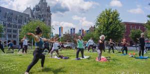 People doing yoga outside of SUNY Plaza