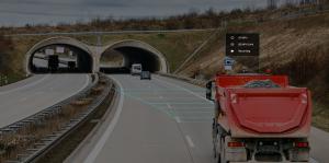 Dump truck with load traveling along highway