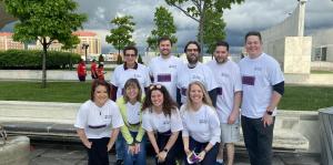 Curran Investment staff in matching shirts outside in tight grouping