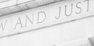 Close up of court building with words Law and Justice on it