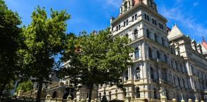 Corner of the New York State Capitol building with blue sky