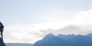 Couple mountain climbing on a high peak