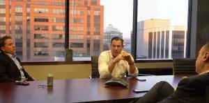 Men in conference room with view of Albany out windows