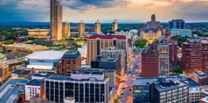 Fisheye lens photo of Albany at twilight showing buildings on State Street with Empire State Plaza in background