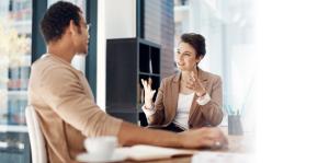 Man and woman talking animatedly in office