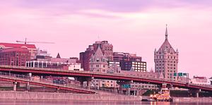 Purple and pink toned photo of the skyline of Albany