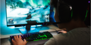 Boy playing video game on computer