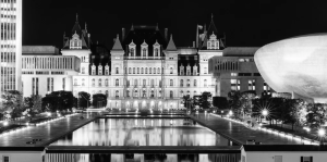 Black and white photo of Empire State Plaza with reflecting pool, The Egg and New York State Capitol building