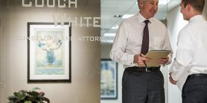 Lawyers in front of Couch White sign on glass