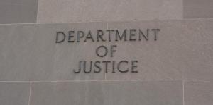 Department of Justice sign on marble wall