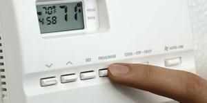 Finger adjusting home thermostat