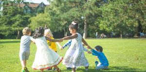 Children holding hands, playing in park