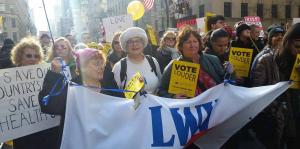 Women's march with signs and banners