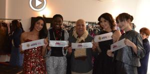 Employees smiling, holding sections of the ribbon from their ribbon cutting