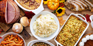 Stock photo of a thanksgiving spread, with mashed potatoes front and center