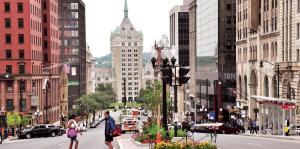 View of downtown albany looking down state street, pedestrians crossing the street in the foreground