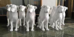 10 blank nipper dog statues sit in a row