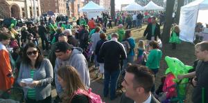 Crowd of people wearing various shades of green celebrating saint patricks day outside