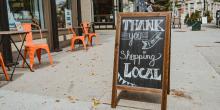 Sandwich board that says "Thank you for shopping local"
