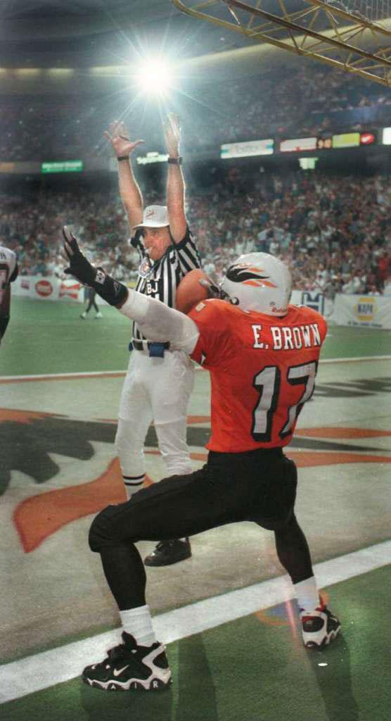 Arena football player celebrating a touchdown in the endzone