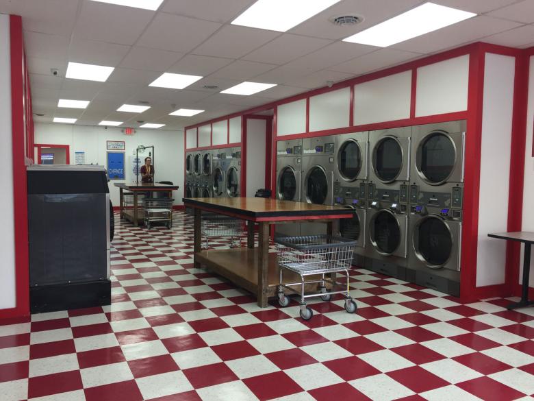 Empty laundromat with red and white checkered floors