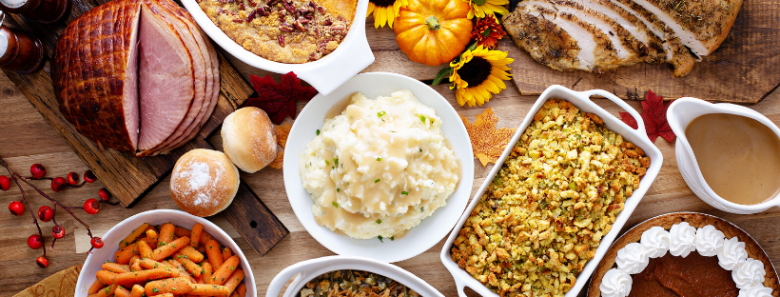 Stock photo of a thanksgiving spread, with mashed potatoes front and center