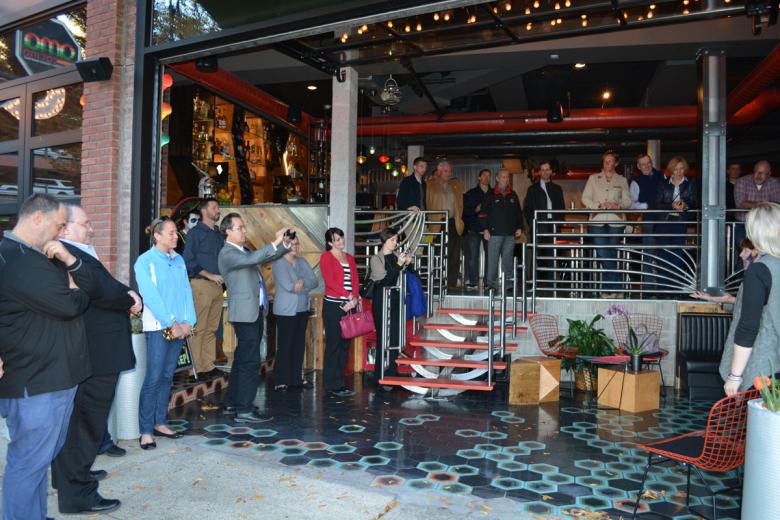 Crowd gathers outside Ama Cocina restaurant to celebrate the grand opening.