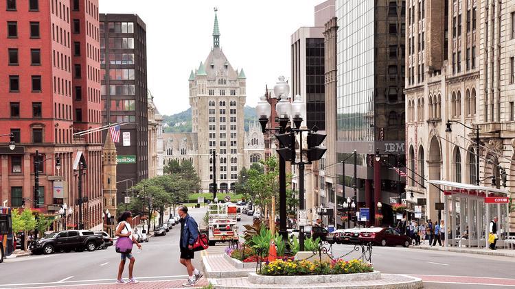 View of downtown albany looking down state street, pedestrians crossing the street in the foreground